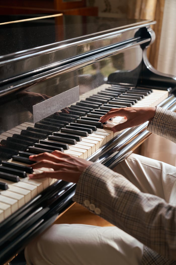 Close-up of a person playing the piano indoors, showcasing skill and passion.